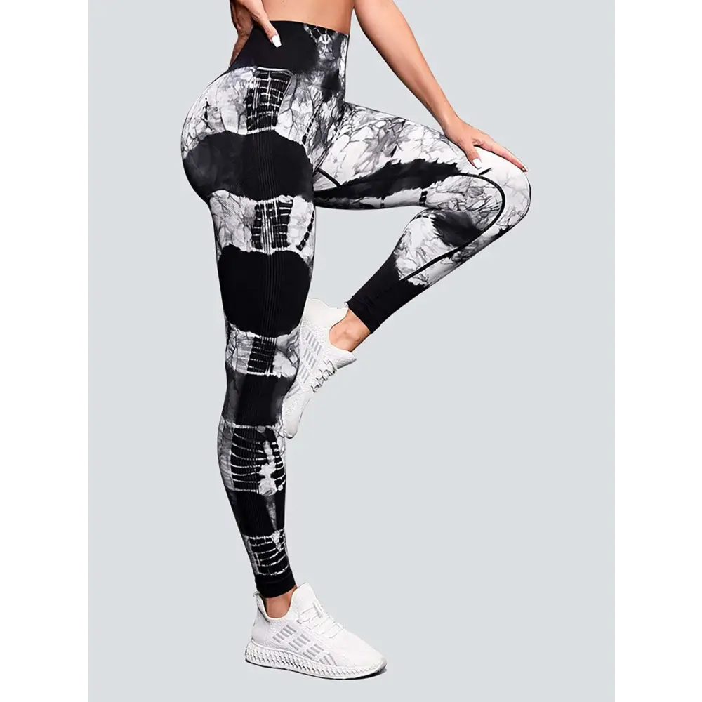 High waist tie dye yoga pants in black and white with a sleek form-fitting design and butt lift effect