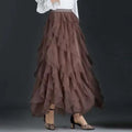 A flowing layered brown tulle skirt with a high-low hemline in a high waist tiered pink slimming mesh skirt style