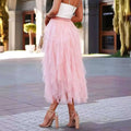 A flowing pale pink high waist tiered slimming mesh skirt with matching waistband made of soft tulle fabric