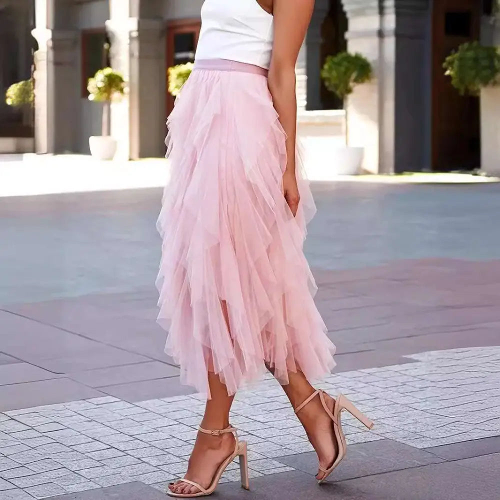 A high waist tiered pink slimming mesh skirt with flowing layers and a matching waistband for elegant wear