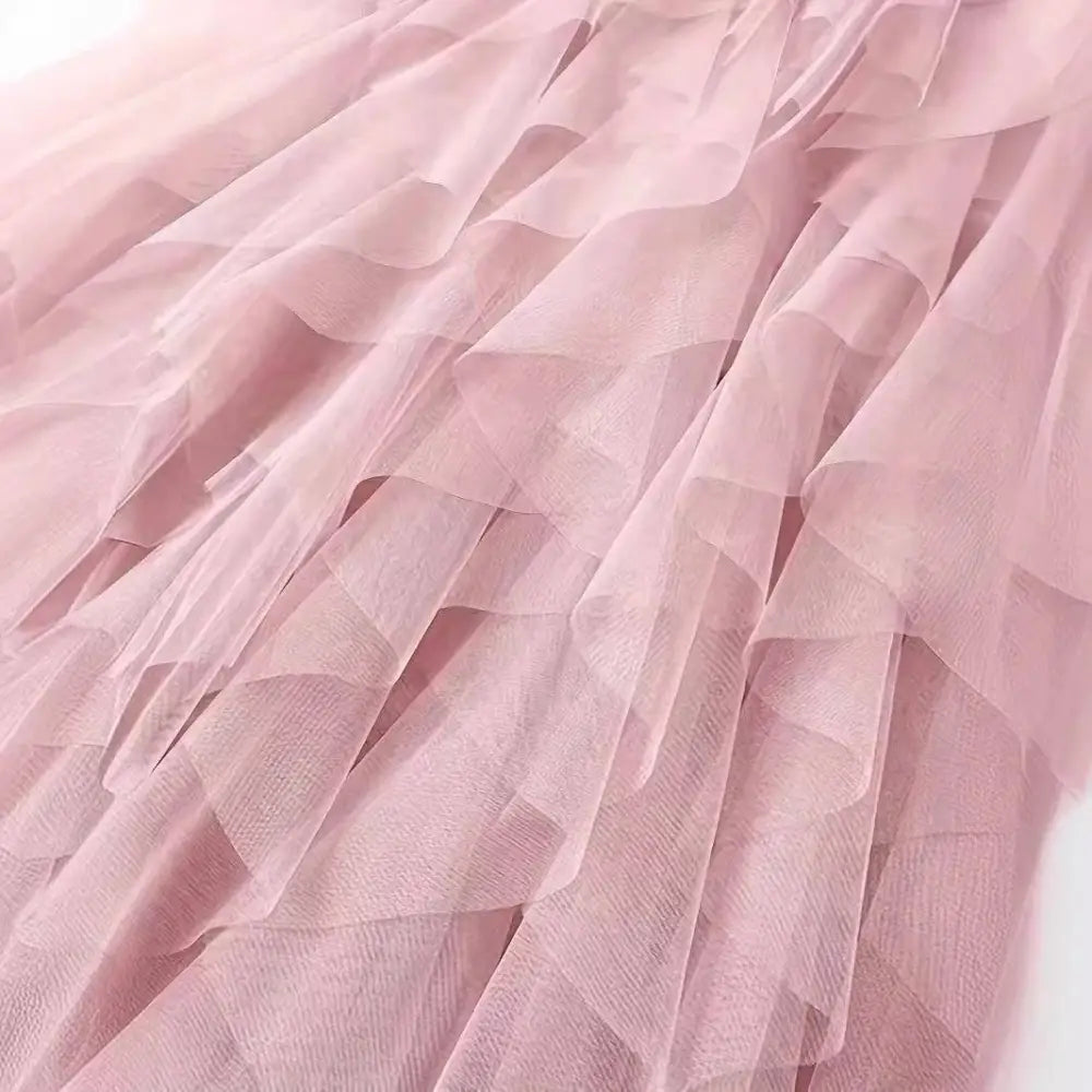 A delicate high waist tiered pink slimming mesh skirt with layered tulle ruffles and an airy flowing texture
