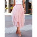 A flowing light pink high waist tiered slimming mesh skirt with matching waistband made of tulle fabric
