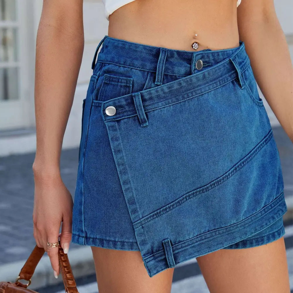 Blue high waist washed irregular denim short skirt featuring a diagonal flap pocket and silver button closures