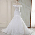 High waist white lace mermaid wedding dress with off-the-shoulder neckline and flowing tulle skirt in white lace mermaid style