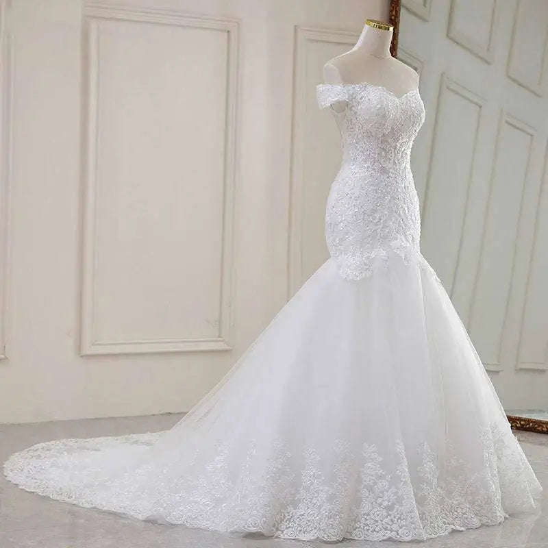 High waist white lace mermaid wedding dress featuring an off-the-shoulder neckline and flowing tulle skirt