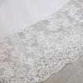 High waist white lace mermaid wedding dress featuring delicate embroidered floral lace trim with scalloped edges