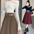 Off-the-shoulder cream ribbed knit crop top paired with brown high waist woolen umbrella skirt with matching belt