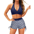 Navy blue high waisted two piece swimsuit with halter top bikini set and white geometric patterned swim shorts with side ties