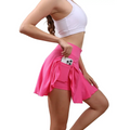 Bright pink high waisted womens tennis skirt with built-in side pocket holding smartphone pleated tennis skirt
