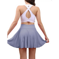A light purple pleated tennis skirt with high waisted design made from soft flowing fabric for womens tennis use