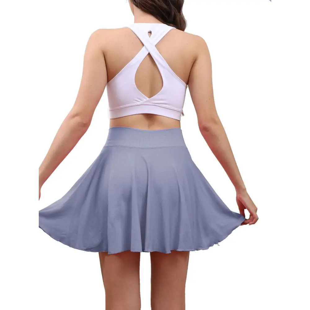 A light purple pleated tennis skirt with high waisted design made from soft flowing fabric for womens tennis use