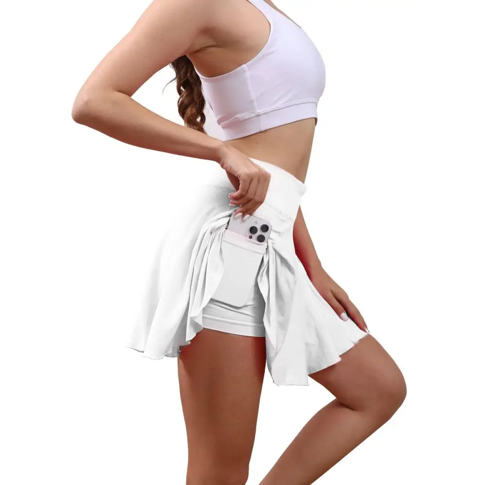 White high waisted womens tennis skirt with built in side pocket holding smartphone for active use