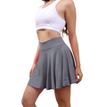 Gray pleated tennis skirt with high waisted elastic band in a womens tennis skirt with pockets design