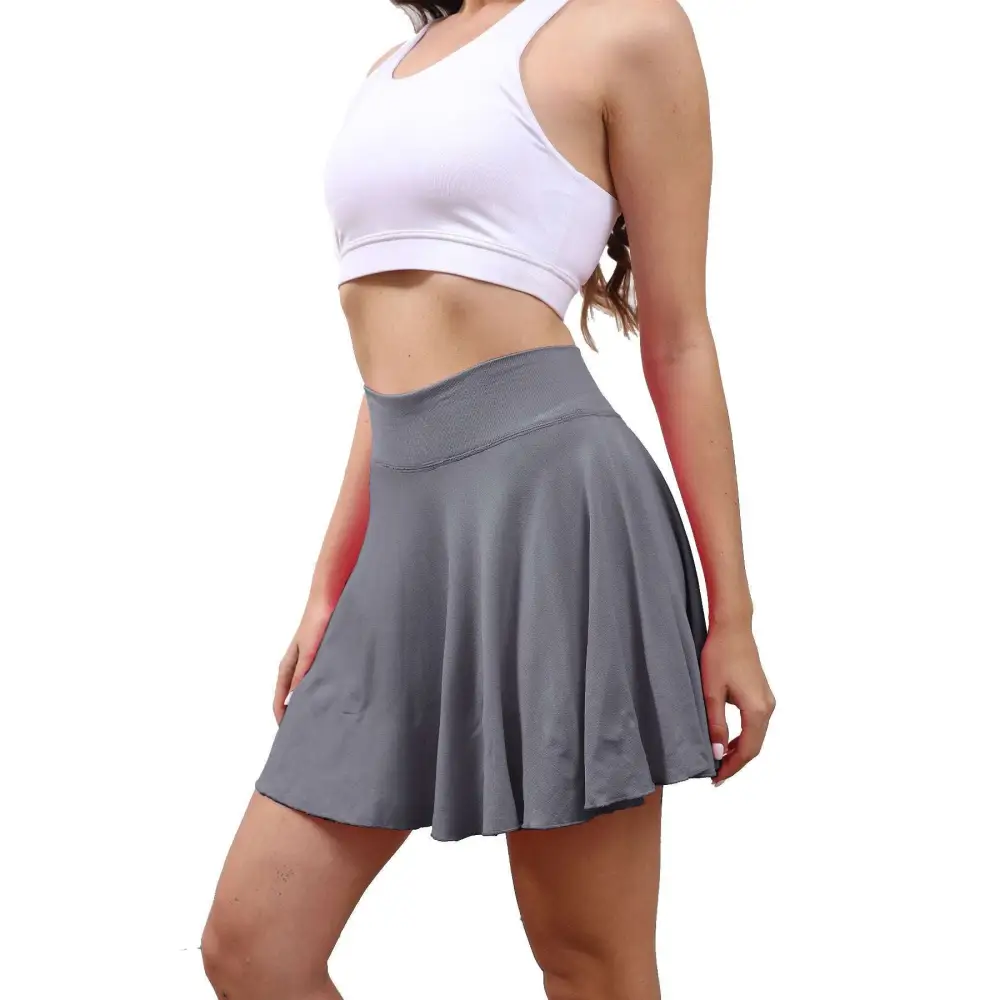 Gray pleated tennis skirt with high waisted elastic band in a womens tennis skirt with pockets design