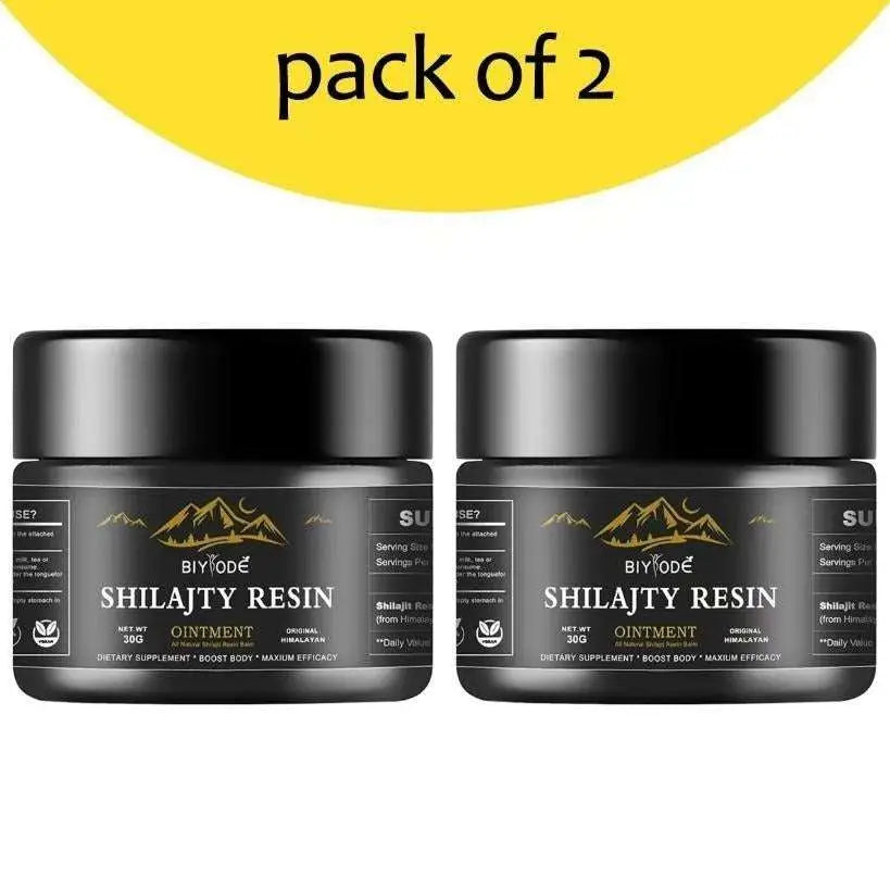 Two black cylindrical jars of biyode shilajit resin ointment with gold mountain graphics for himalayan shilajit use