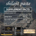 Black jar of himalayan shilajit resin ointment with gold mountain logo, matching box, and wooden applicator sticks for shilajit gummies