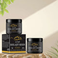 Black cylindrical jar of biyode shilajit resin ointment with gold mountain logo beside its box for himalayan shilajit gummies