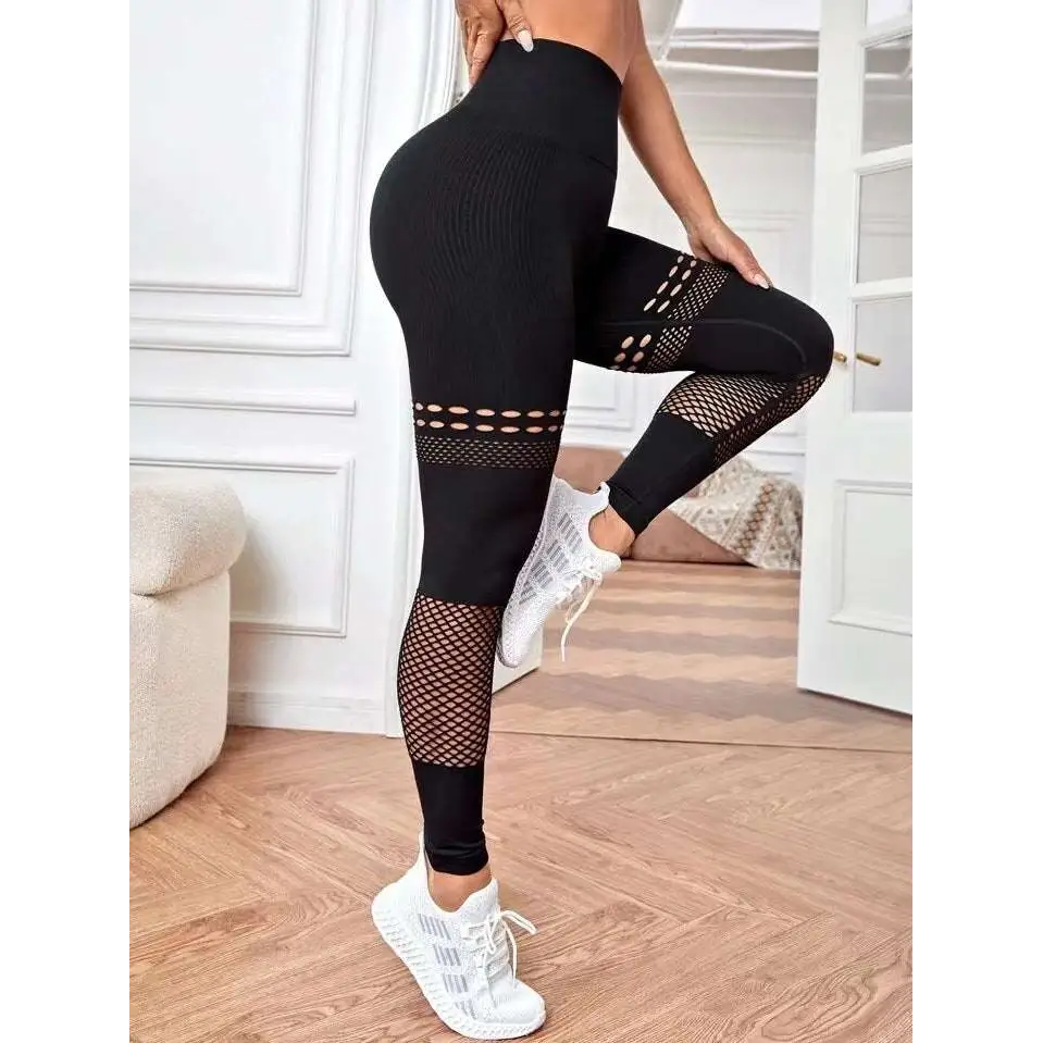 Black high-waisted hollow seamless yoga pants with mesh panels and cut-out details for training and workouts