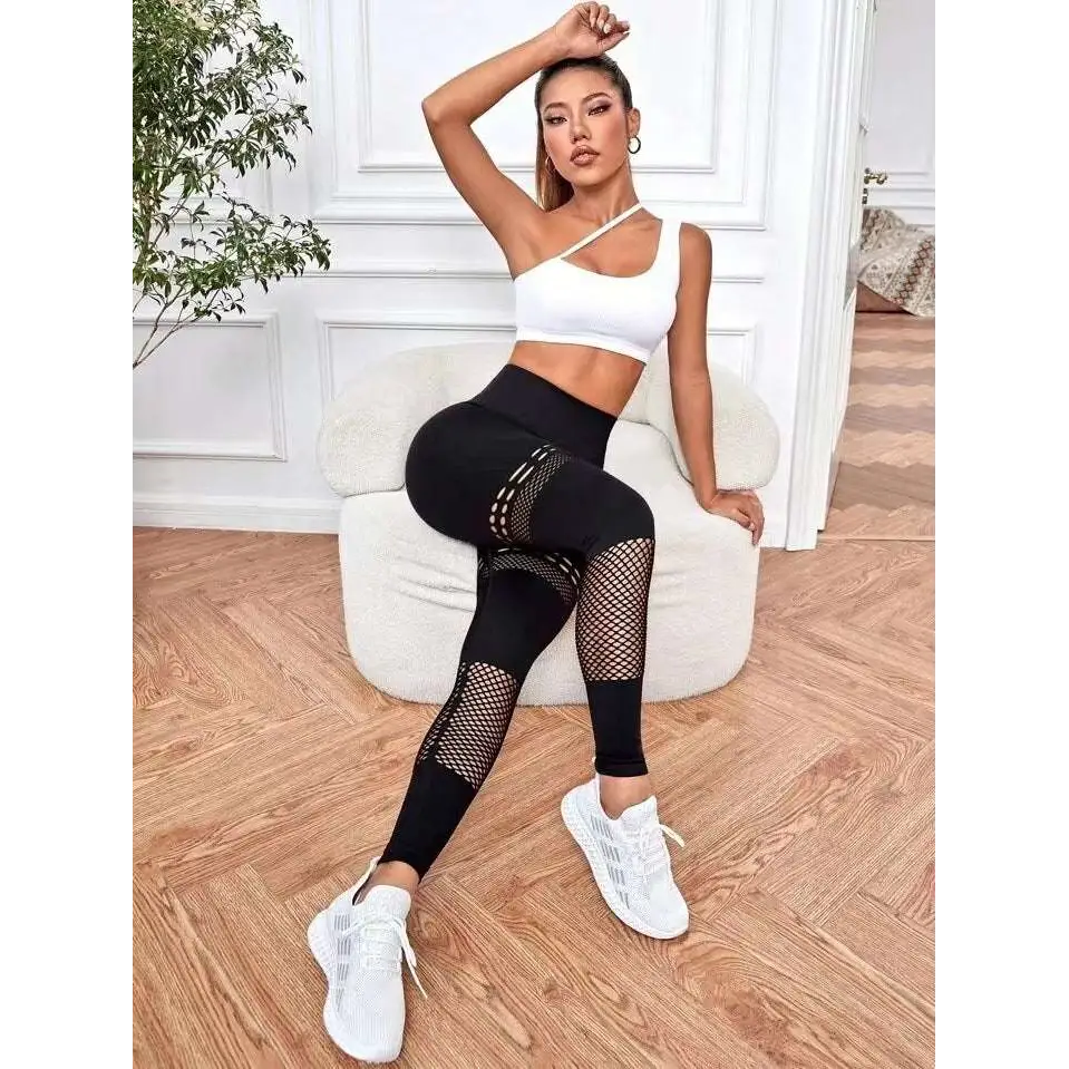 Black high-waisted hollow seamless yoga pants with mesh panels featuring a seamless fit for yoga pants training