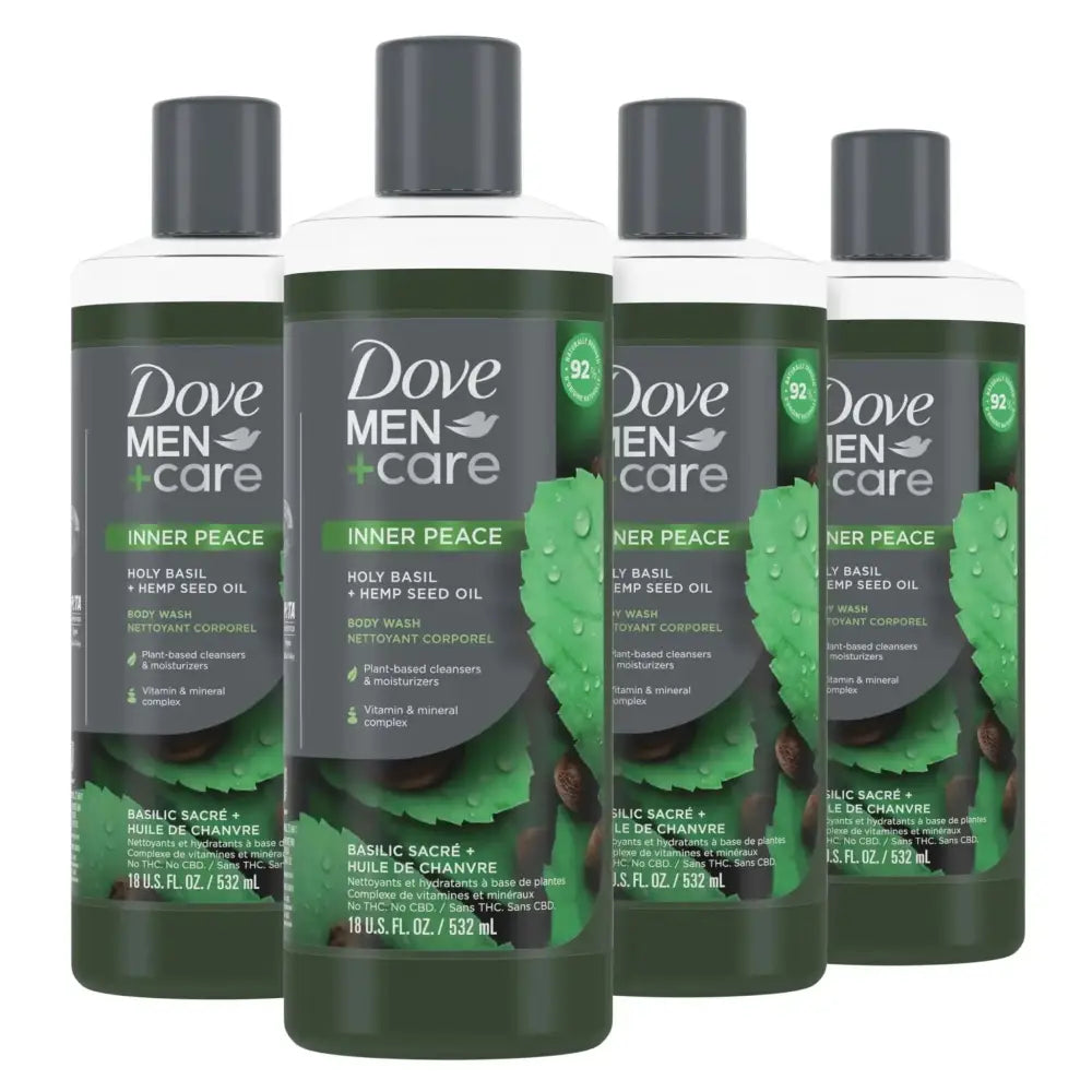 Four bottles of dove men+care holy basil and hemp seed oil body wash with dark green labels featuring basil imagery