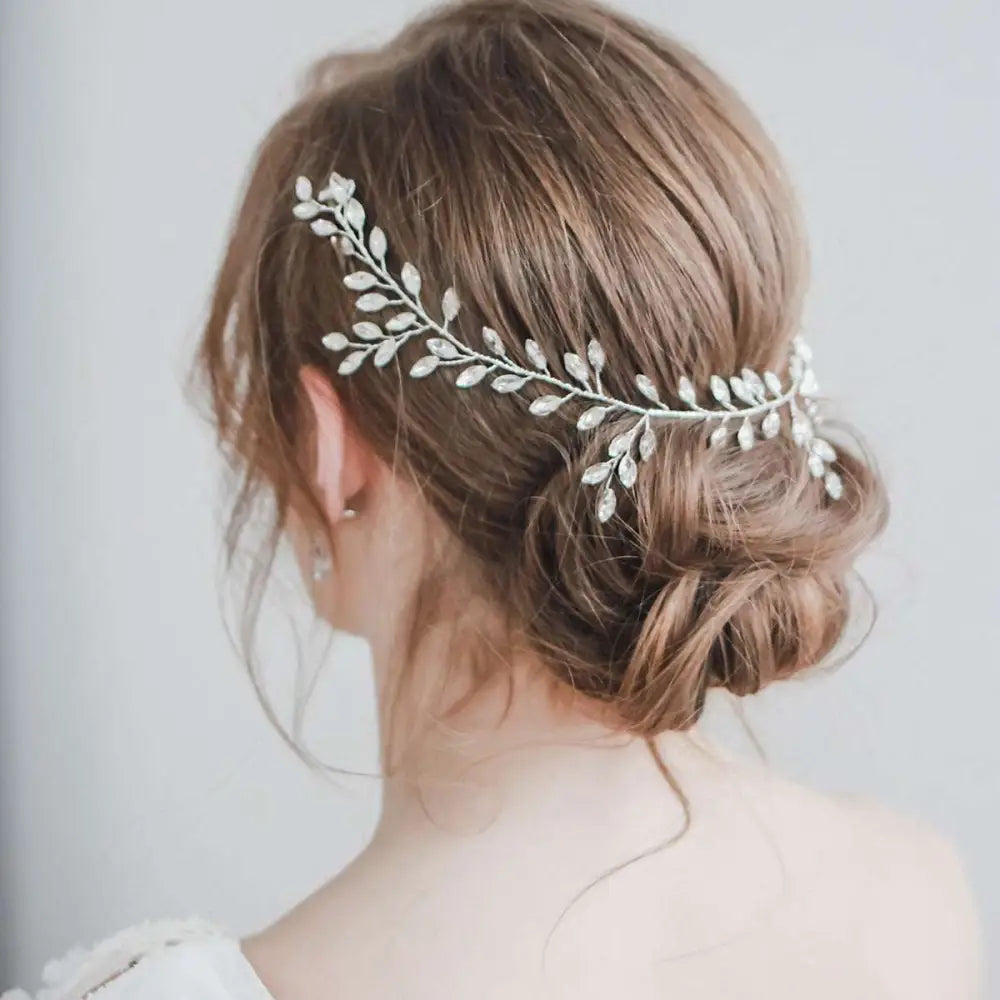 Horse eye silver flexible chain wedding hair accessory with silver leaf design and sparkling crystal embellishments