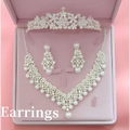 A sparkling silver tiara with crystal and pearl details elegantly displayed in a pink velvet box for hot bridal jewelry