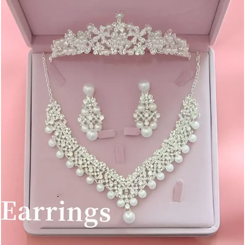 A sparkling silver tiara with crystal and pearl details elegantly displayed in a pink velvet box for hot bridal jewelry