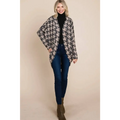 A cozy long-sleeved houndstooth open front knit cardigan in beige and black featuring a bombom houndstooth cocoon knit pattern