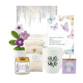 White ceramic mug with black cursive hug in a mug text featured in hug in a mug sympathy gift basket for mug sympathy gift