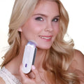 A sleek white and silver induction type lady hair removal device with precise hair removal and a glowing purple induction type tip