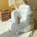 White inflatable baby chair with lemon pattern and built-in cup holder for dining and bath use