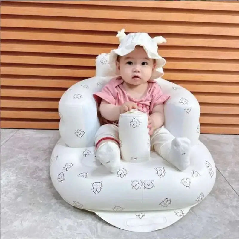 White inflatable baby chair with plush texture and cartoon animal prints for dining and bath use