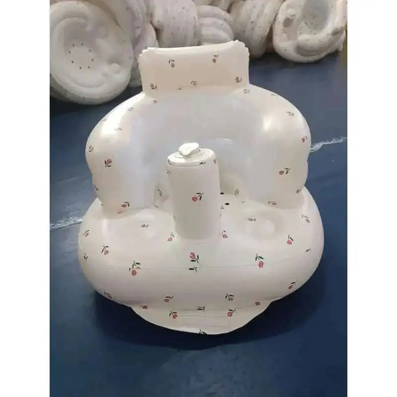 White inflatable baby chair with floral pattern and central pump designed for dining and bath use
