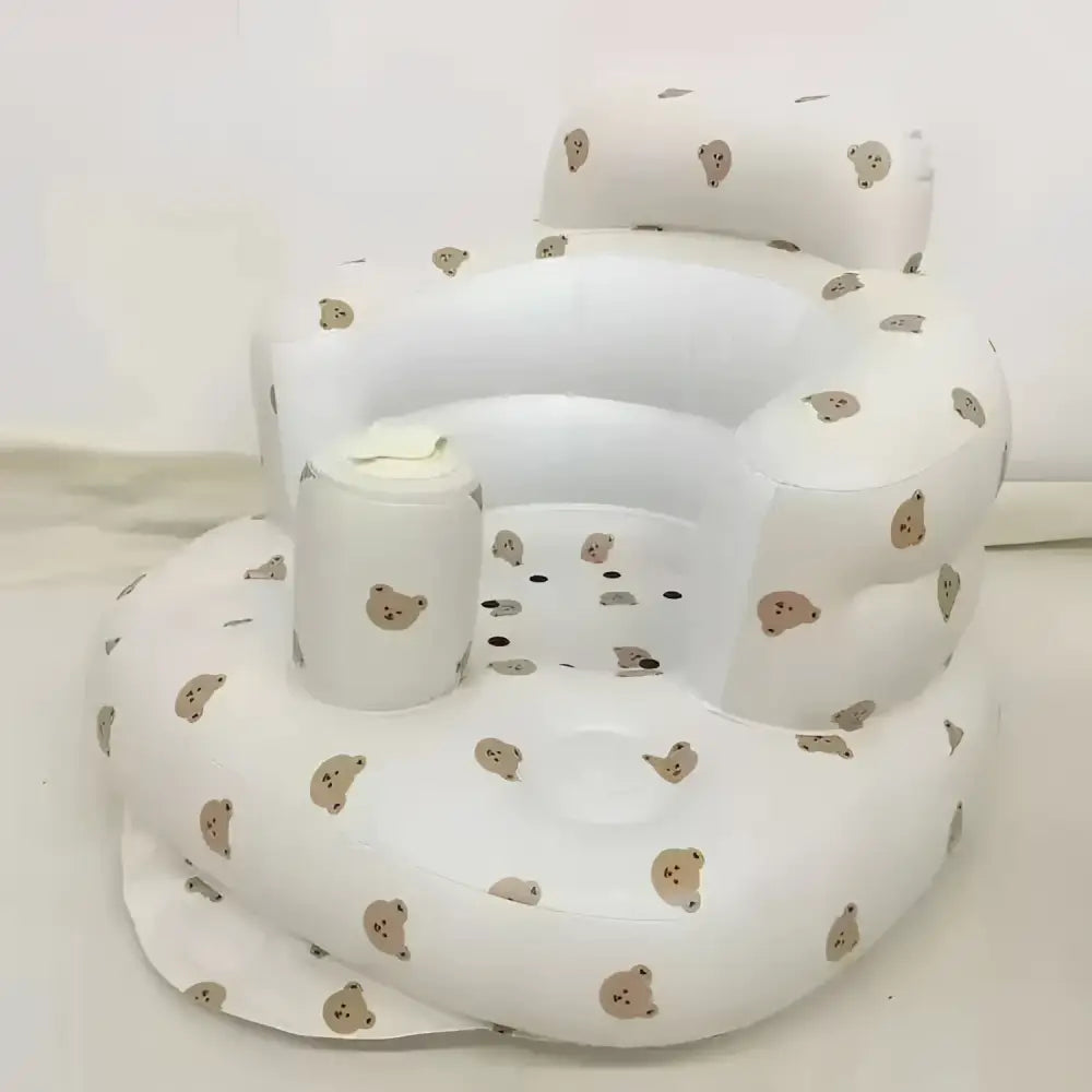 White inflatable baby chair with beige bear face patterns designed for dining and bath use