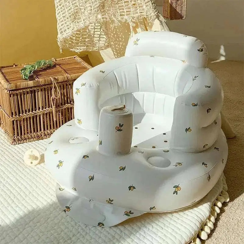 White inflatable baby chair with lemon pattern and built-in cup holder for dining and bath use