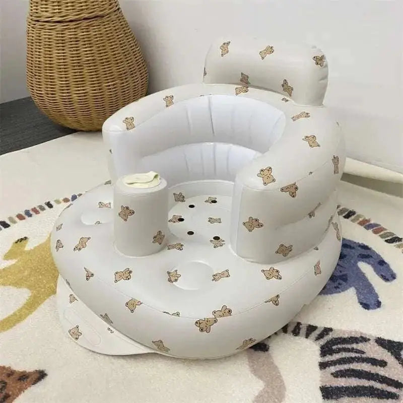 White inflatable baby chair with soft cushioned design and beige teddy bear pattern for dining and bath use