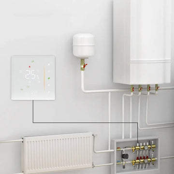 White intelligent home heating digital thermostat switch displaying 25°c mounted on wall near heating components