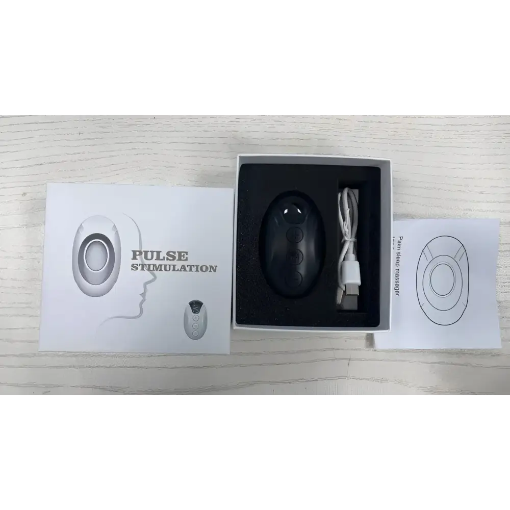Black oval-shaped intelligent relieve anxiety pulse stimulation device with three buttons in foam inside white box for anxiety sleep instrument