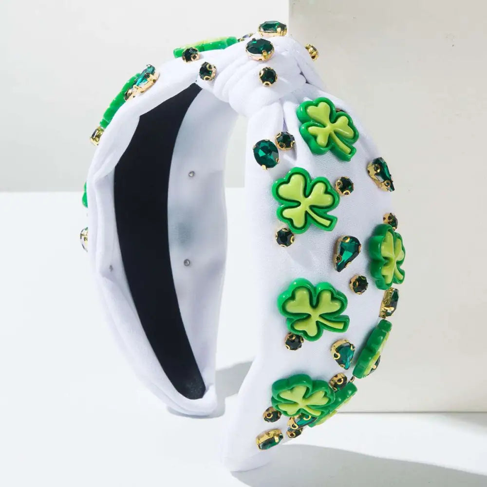 White knotted headband with irish green shamrock rhinestone charms and emerald rhinestones in gold-tone settings