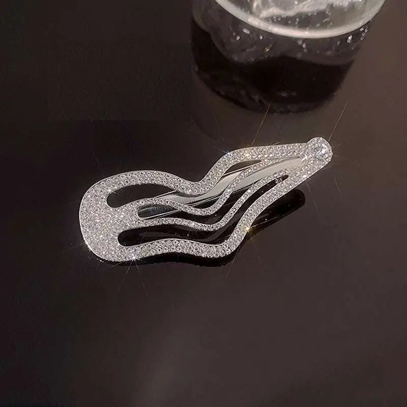 A sparkling silver sweet cool rhinestone hair clip with irregular lines bang and wavy intricate rhinestone detailing