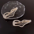 Gold-toned hair clips with irregular lines bang design and sweet cool rhinestone embellishments for elegant styling