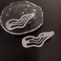 Shiny silver hair clips with sweet cool rhinestone accents in an irregular lines bang wavy layered design
