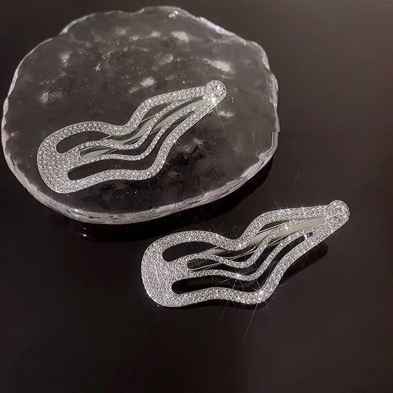 Shiny silver hair clips with sweet cool rhinestone accents in an irregular lines bang wavy layered design