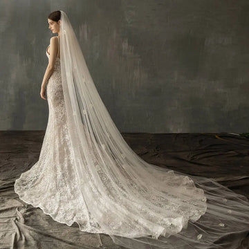 Ivory lace bridal church wedding gown with fitted bodice and elaborate pearl long tail floor-length train