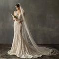 Ivory lace bridal church wedding mermaid gown with fitted bodice pearl long tail and intricate floral embroidery