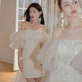 Ivory lace cinched waist miniskirt fairy dress with shimmering sequins and delicate ruffled sleeves in sheer fabric