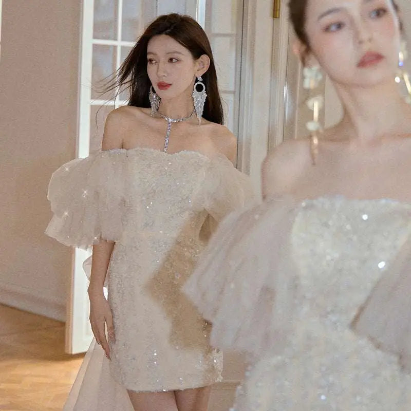 Ivory lace cinched waist miniskirt fairy dress with shimmering sequins and delicate ruffled sleeves in sheer fabric