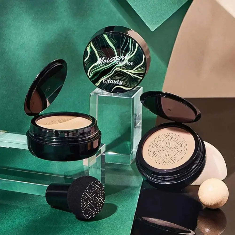 Black circular foundation compact with green white marbled lid moisture cushion containing beige air cushion foundation