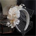 Elegant ivory petal mesh hairband featuring delicate white floral lace, pearls, and satin petals for refined style