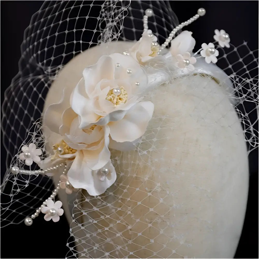 Elegant ivory petal mesh hairband featuring pearl lace, delicate silk flowers, and a sheer veil for formal occasions